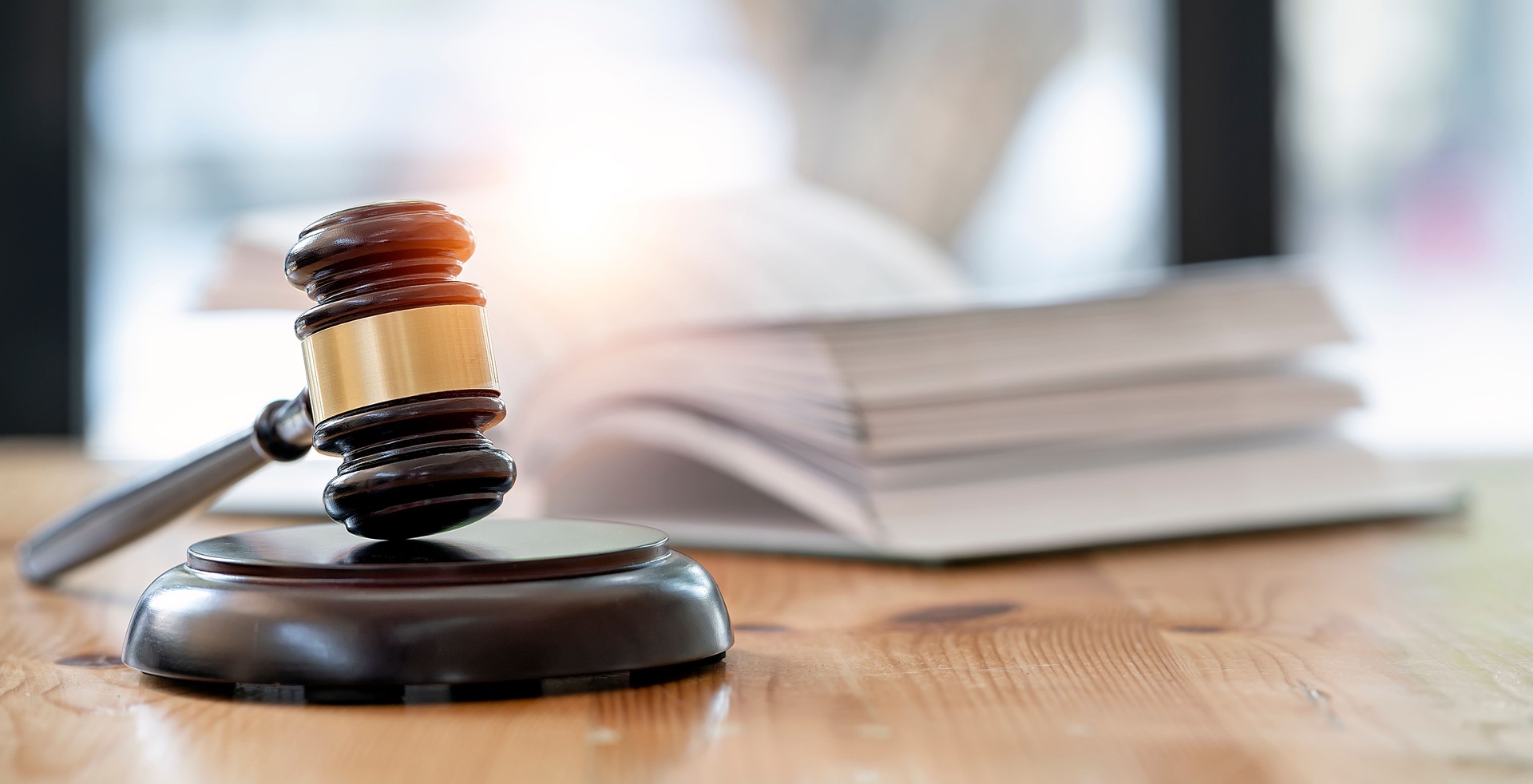 Wooden brown judge gavel on the table, copy space, banner background.